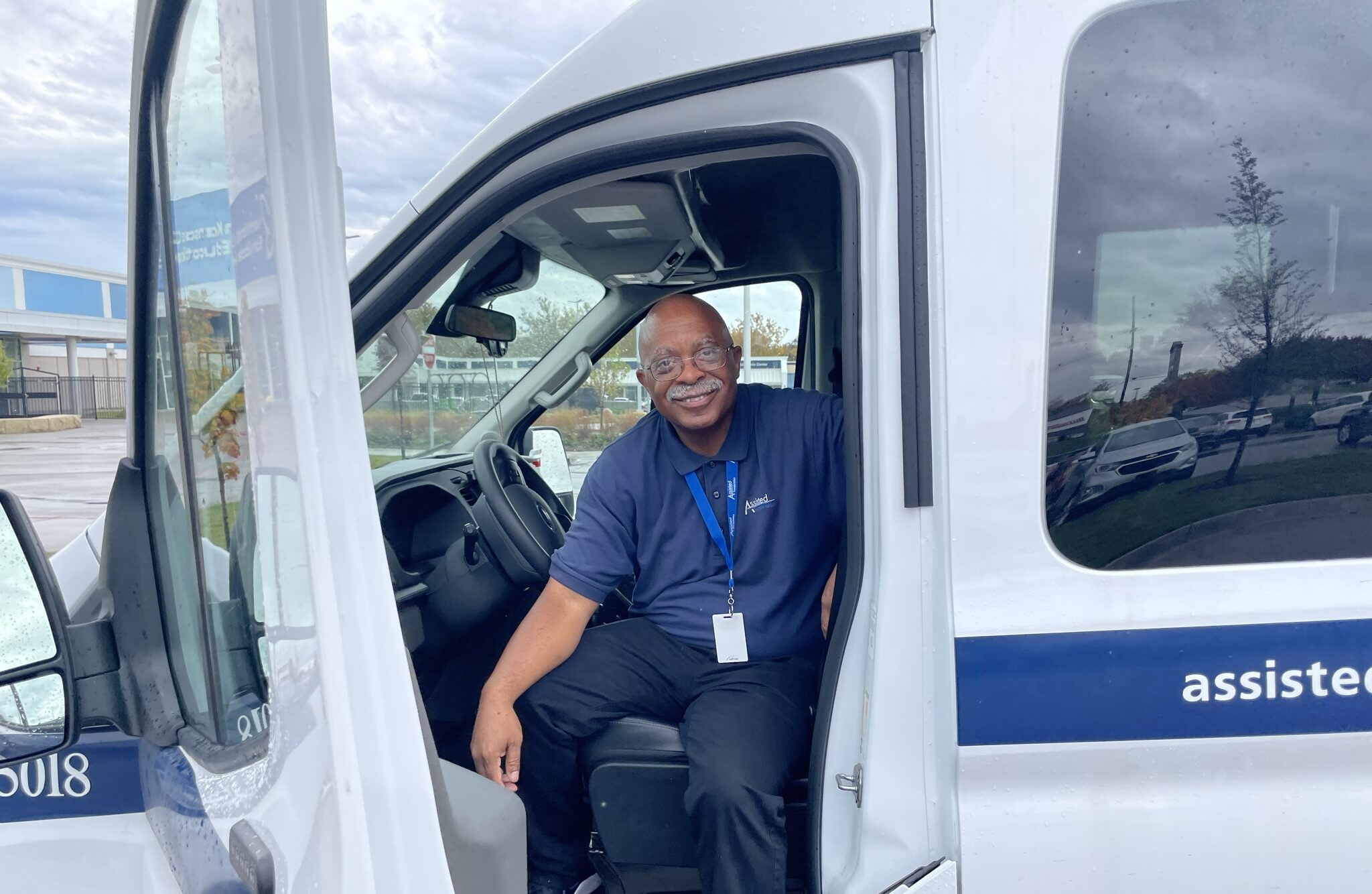 uniformed driver sits in the driver's seat of an assisted van